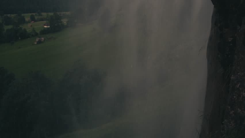 village Lauterbrunnen waterfall Staubbach travel. highest waterfall in Europe. slow motion video of water falling over stones from high mountain cliff rock. landscapes of Switzerland mountain nature