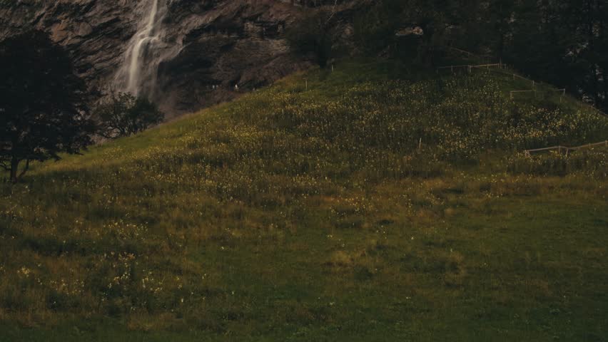 village Lauterbrunnen waterfall Staubbach travel. highest waterfall in Europe. slow motion video of water falling over stones from high mountain cliff rock. landscapes of Switzerland mountain nature