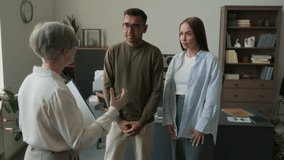 Happy biracial couple gently embracing reuniting after relationship crisis then gratifying female psychotherapist for help in office - Powered by Shutterstock - Get 15% off with code: PIKWIZARD15