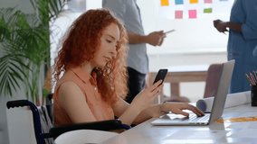 Seated woman lifting smartphone and activating technology interface while processing security data. Collaboration, accessibility, technology, innovation, teamwork, digital, creativity - Powered by Shutterstock - Get 15% off with code: PIKWIZARD15