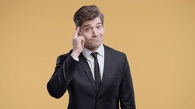 Smart businessman points to head, taps temple, suggesting smart thinking or idea - Powered by Shutterstock - Get 15% off with code: PIKWIZARD15