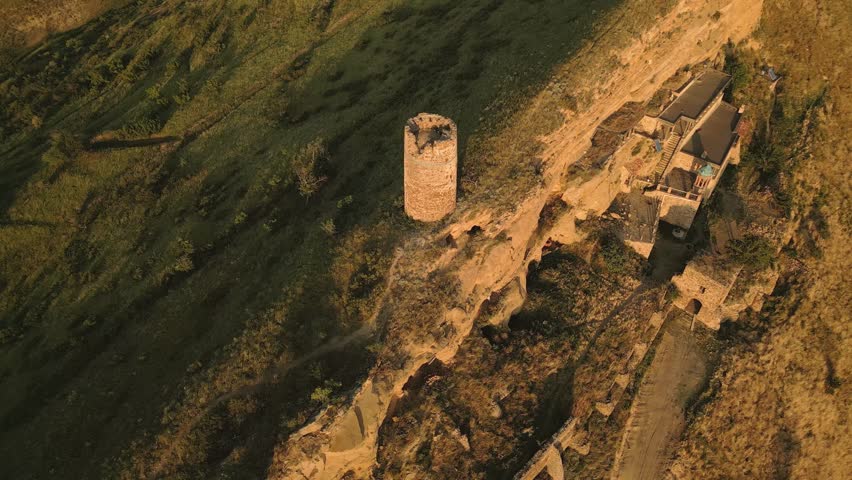 Aerial top down view of an ancient stone watchtower standing alone on a remote ridge in David Gareja, Georgia, symbolizing medieval defense, isolation, and border vigilance. - Powered by Shutterstock - Get 15% off with code: PIKWIZARD15