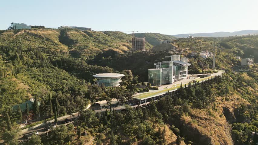 Aerial view of Georgian businessman Bidzina Ivanishvili modern private complex with futuristic architecture nestled in the green hills of Tbilisi capital. Georgia dream political party founder home