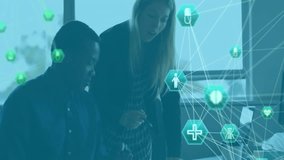 Woman pointing at laptop screen and man taking notes activating medical icon overlay for analysis. Collaboration, healthcare, technology, analytics, innovation, professionalism, digital - Powered by Shutterstock - Get 15% off with code: PIKWIZARD15