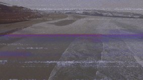 Wind-driven waves rolling onto shore, cresting and receding, revealing pools with static flickering. Seascape, nature, tranquil, minimalist, outdoors, environment, calm - Powered by Shutterstock - Get 15% off with code: PIKWIZARD15