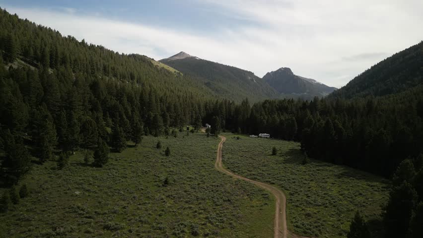 Low aerial of RVs camped in beautiful Salmon National Forest in meadow in Leadore Idaho