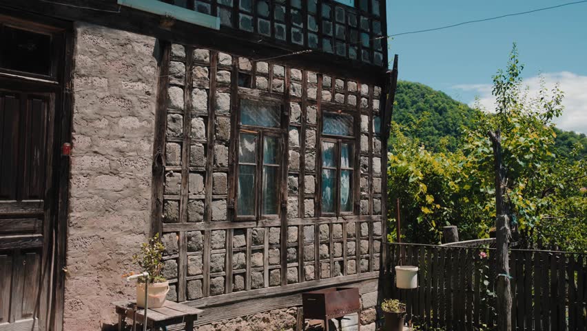 Old wooden house in the mountains deep in the forest. neglected cabin in a farmer field


