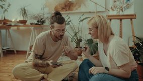 Cheerful couple of artists laughing and having fun while painting together in their art studio - Powered by Shutterstock - Get 15% off with code: PIKWIZARD15