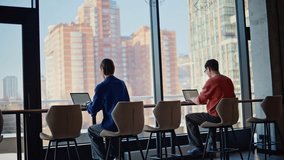 Colleagues busy of online work at contemporary workspace. Two freelancers focused on laptops creating project together at coworking space. Hardworking man manager asking advice in professional woman. - Powered by Shutterstock - Get 15% off with code: PIKWIZARD15