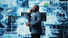 Black entrepreneur using mobile phone call to interact with people, shares insight on cybernetic platforms and AI interfaces. Machine learning and predictive analytics for growth. Camera A. - Powered by Shutterstock - Get 15% off with code: PIKWIZARD15