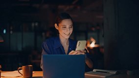 Manager ordering online purchase by cellphone app in night office closeup. Smiling businesswoman browsing smartphone social media late evening. Happy freelancer receiving salary notification indoors. - Powered by Shutterstock - Get 15% off with code: PIKWIZARD15