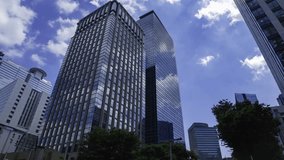 A timelapse of moving cloud reflecting the office building at the city wide shot - Powered by Shutterstock - Get 15% off with code: PIKWIZARD15
