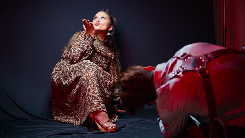 Elegant woman displays her pose under spotlight, Photographer takes picture of smiling beauty, Fashion Model wears bold outfit in studio shoot, Confident girl sits with style for the camera, Portfolio