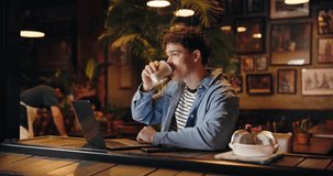Coffee shop, hybrid work and man typing on laptop to research story or review email for journalism. Computer, drink and freelancer in cafe for news article, editing headline or fact checking at night - Powered by Shutterstock - Get 15% off with code: PIKWIZARD15