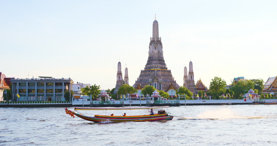 Wat arun temple of dawn travel boat on Chaophraya river sunset light sightseeing in Bangkok Thailand