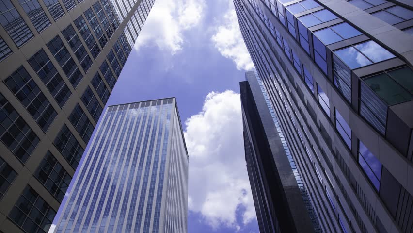 A timelapse of moving cloud reflecting the building at the city low angle view tilt