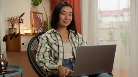 Cheerful Asian Korean woman talking online conference meet laptop greeting video call female girl consultant designer showing colors sample design project businesswoman business manager home indoors - Powered by Shutterstock - Get 15% off with code: PIKWIZARD15