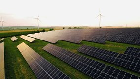 Wind turbines generating green energy electric.Solar panels park and wind turbines at sunset.Green energy reduce carbon emissions and makes earth cleaner and more ecological. - Powered by Shutterstock - Get 15% off with code: PIKWIZARD15