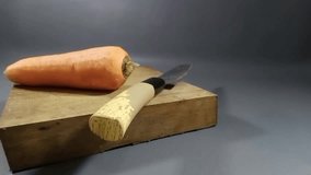 hand slicing carrots using a knife, carrots sliced ​​using a sharp knife on a wooden chopping board - Powered by Shutterstock - Get 15% off with code: PIKWIZARD15
