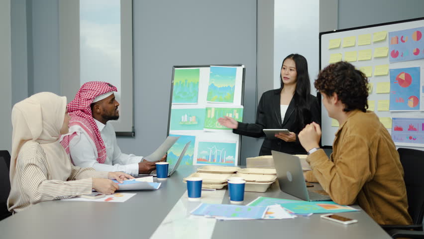 Asian businesswoman presents project strategies to a diverse team during a meeting, planning and development strategy using graphs, charts, presented at company sales strategy marketing meeting - Powered by Shutterstock - Get 15% off with code: PIKWIZARD15