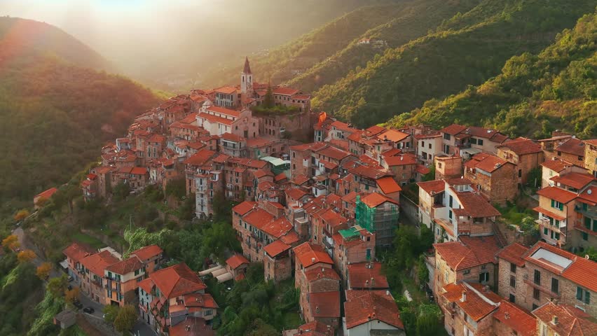 Aerial view of the picturesque town of Apricale at sunset in, province of Imperia, Liguria, Northern Italy. Charming medieval village is nestled in the mountains and surrounded by scenic landscapes.