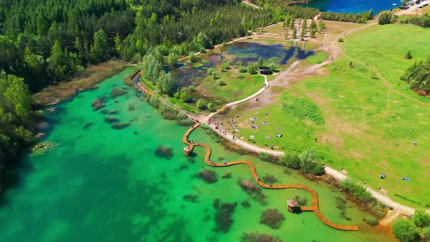 Aerial view of Park Grodek in Jaworzno, Southern Poland. Known as the Polish Maldives, the park features turquoise lakes in a former quarry, wooden walkways, and lush natural surroundings.