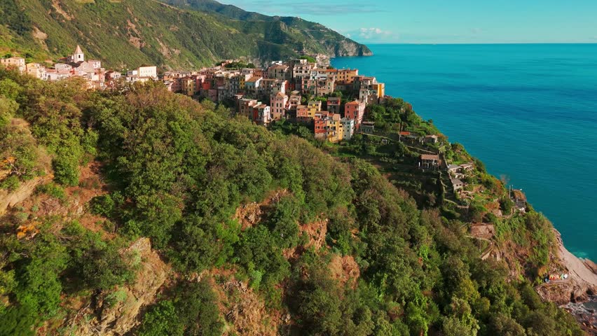 Aerial view of the Corniglia town in the famous Cinque Terre, Italian Riviera, Liguria, Italy. Stunning historic village with colorful buildings nestled between cliffs and the Ligurian Sea. 