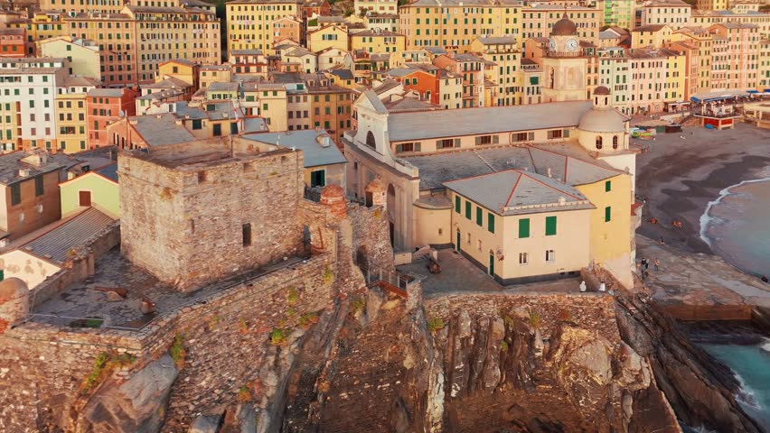 Aerial view of the picturesque historic town of Camogliat sunset in Liguria, Italy. Historic Castello della Dragonara and Basilica di Santa Maria Assunta with colorful buildings above Ligurian Sea