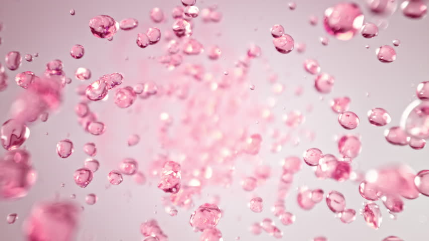 Super Slow Motion Shot of Flying Pink Liquid Drops Towards Camera at 1000fps.