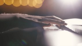 Female hands playing gentle piano melody in warm studio light with bokeh background. Relaxing and inspiring close-up video of musician enjoying creativity, peace and beauty of music in elegant - Powered by Shutterstock - Get 15% off with code: PIKWIZARD15
