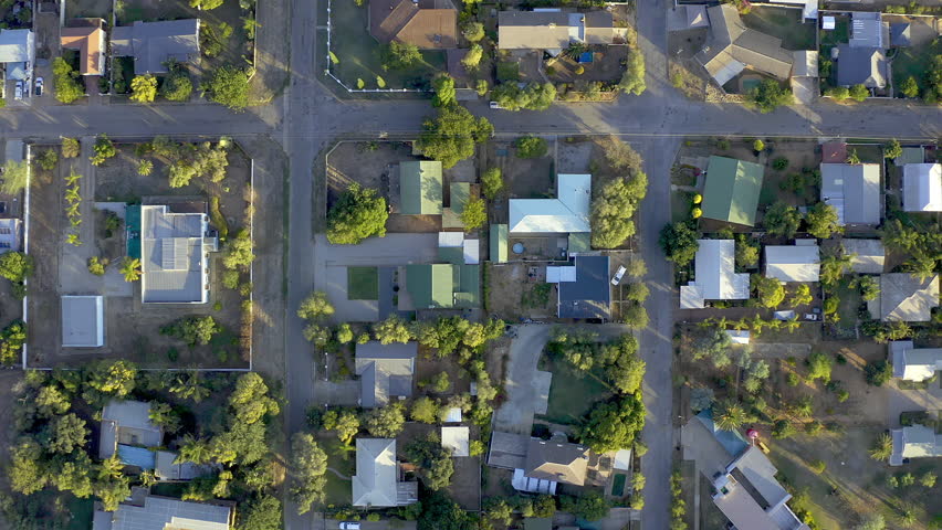 Real estate, buildings and overhead for home, house or apartment living in a small town residential area. Property, roof and neighborhood with urbaninzation development alongside the street or road