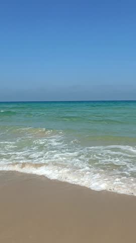 Tropical beach, sea, sand. Sea view from the beach on a summer day. Beach area. Video for the blog, vertical screen
