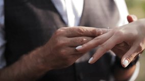 Man placing engagement ring on woman finger - Powered by Shutterstock - Get 15% off with code: PIKWIZARD15