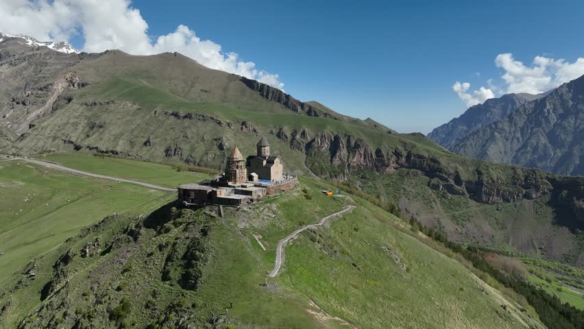 Aerial view of ancient Gergeti Trinity church Tsminda Sameba, near mount Kazbek, a landmark of Georgia, Caucasus mountains. May 26 2025