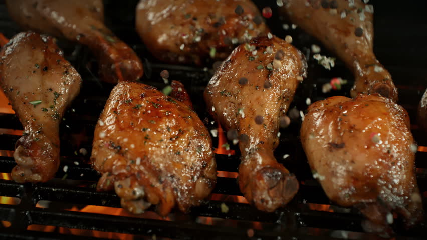 Super Slow Motion of Seasoning Falling on Chicken Pieces on Grill with Camera Motion at 1000fps.