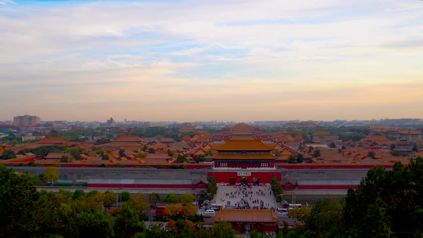 Gaze upon the stunning panoramic view of Beijing's Forbidden City as the sun sets, casting a warm glow over the historic rooftops and majestic structures, attracting visitors.