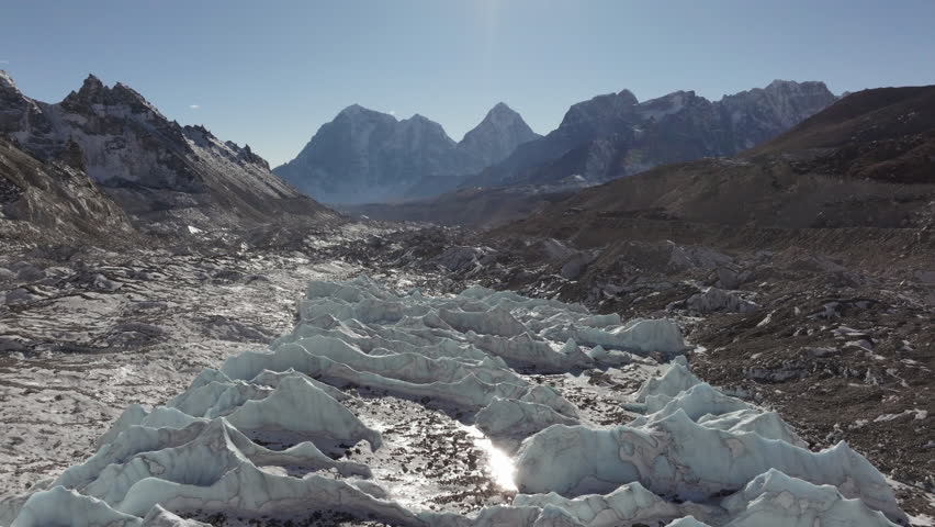 Aerial View of a Glacial Valley in the Himalayas, Capturing the Majestic Snow-Capped Peaks and Rocky Terrain of Nepal