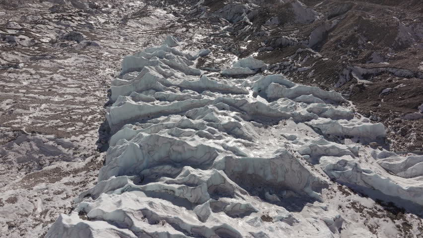 Aerial View of a Glacier in the Himalayas of Nepal, Highlighting the Majestic Rocky Terrain and Snow-Capped Peaks