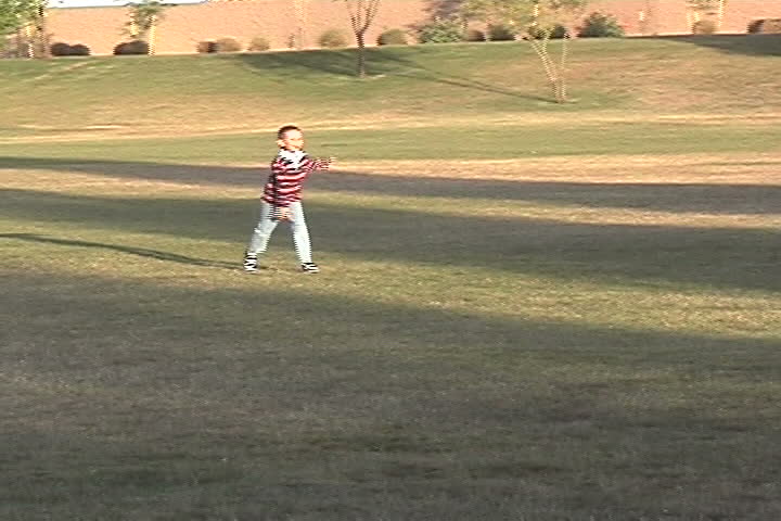 Boy running in a grass park