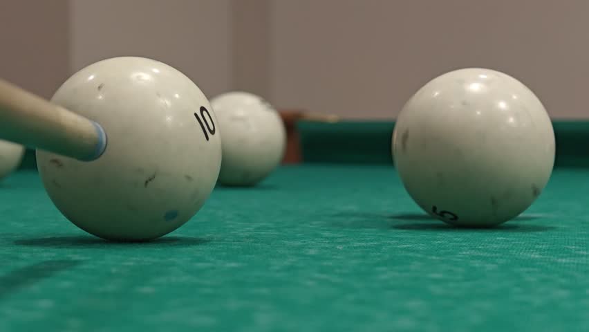 Russian pyramid billiards, close-up view of the struck ball and cue stick tip, loud shot
