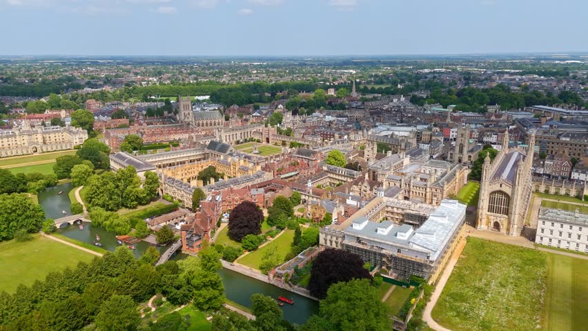 Cambridge University campus with its historic buildings, River Cam, and green spaces, seen from above on a sunny day