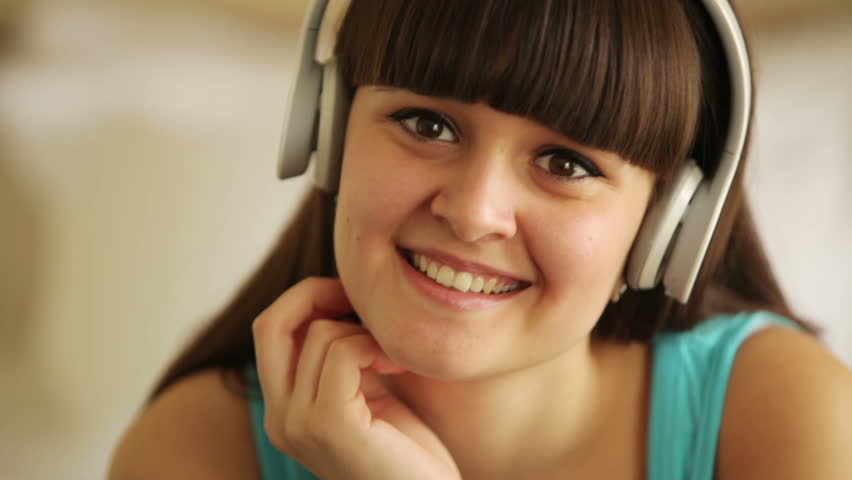 Cute woman listening music and smiling
