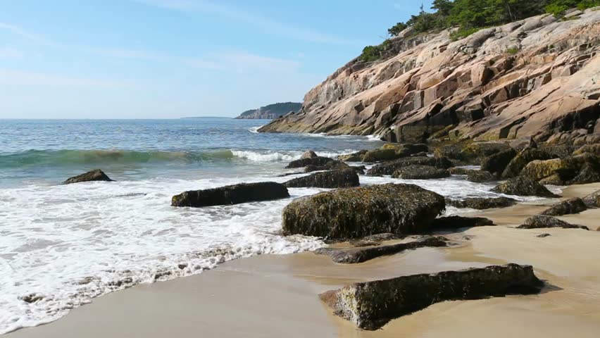 Waves crash on a rocky beach in acadia national park
