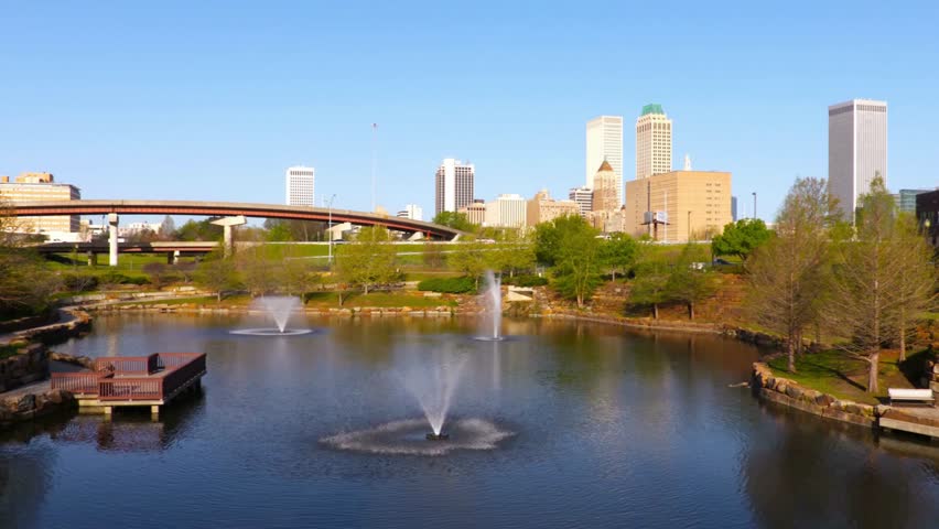 Tulsa skyline reflects in the pond on a sunny day