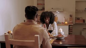 Romantic black couple sharing intimate dinner moment, connecting deeply while enjoying candlelit meal in cozy home kitchen setting - Powered by Shutterstock - Get 15% off with code: PIKWIZARD15