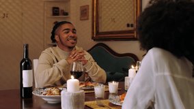 Young man listens carefully to his partner during a romantic candlelit dinner, enjoying conversation and connection - Powered by Shutterstock - Get 15% off with code: PIKWIZARD15