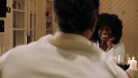 Young couple enjoying a romantic dinner at home, sharing wine, food, and intimate conversation by candlelight - Powered by Shutterstock - Get 15% off with code: PIKWIZARD15