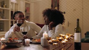 Young african american couple sharing intimate moment, sipping red wine and conversing during romantic candlelit dinner, expressing deep connection and affection - Powered by Shutterstock - Get 15% off with code: PIKWIZARD15
