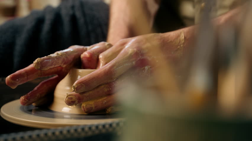 Craftsman unrecognizable man making vase jug pot wet clay pottery wheel craftsmanship workshop hobby potter artisan handicraft ceramic sculpting shaping modeling studio male master class hands create