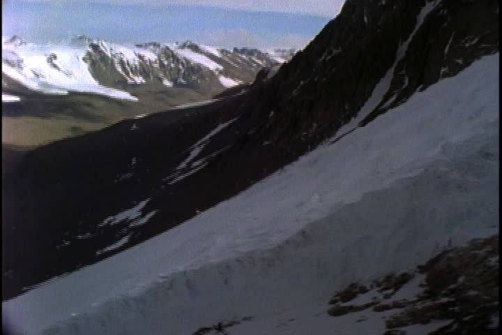ANTARCTICA - CIRCA FEBRUARY 1997: Camera slowly moves up along ice sheet to top of mountain.
